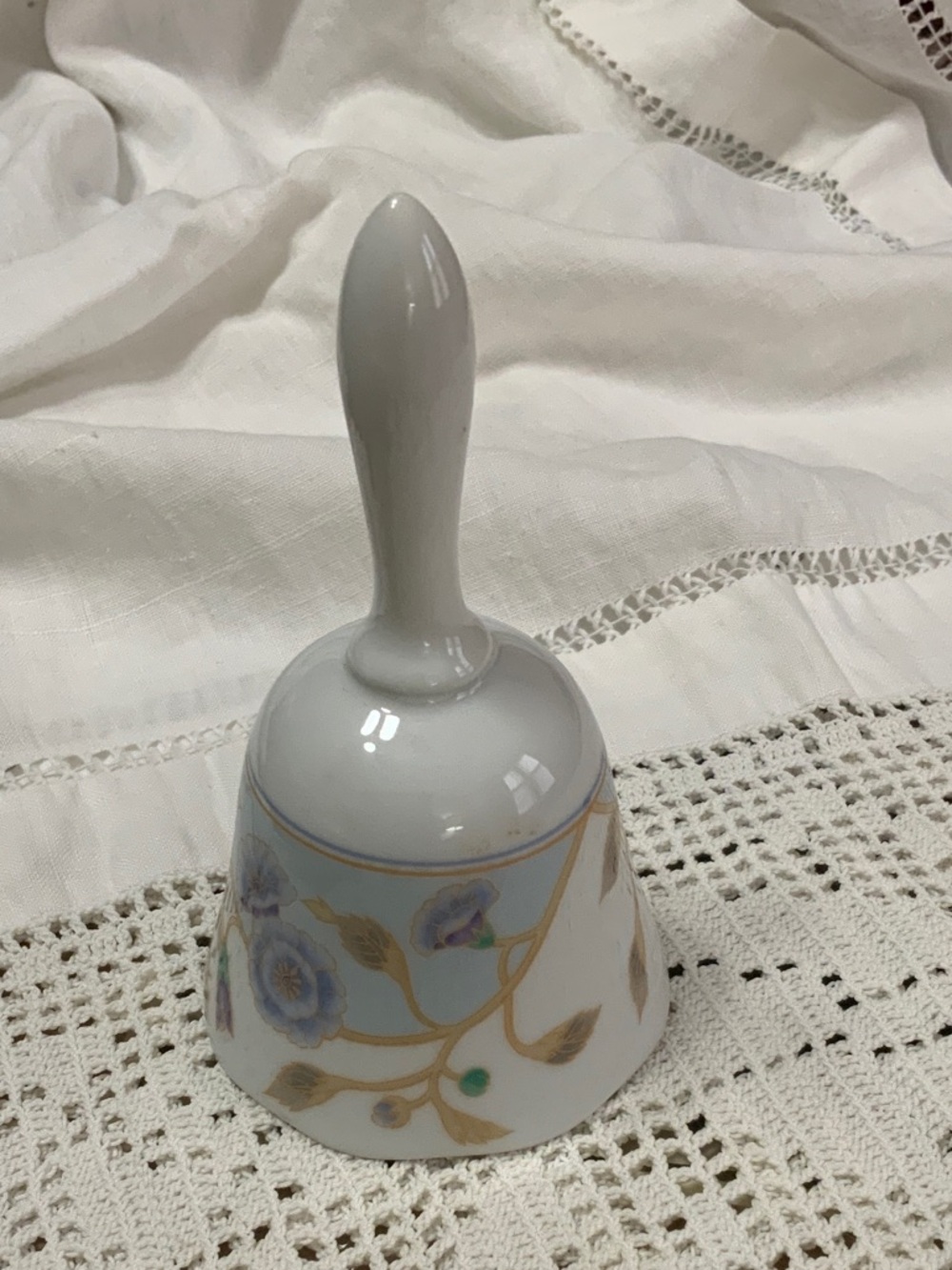 Porcelain Decorative Hand Bell with Blue Floral Motif and Gold Trim